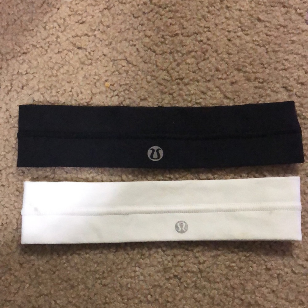 two LuluLemon headbands. one black, one white.